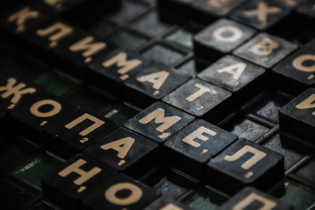 Detailed close-up of black Scrabble tiles with Cyrillic letters on a board.